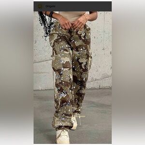 Fashion Nova Women’s Camo Cargo Pants with blue paint splatter.